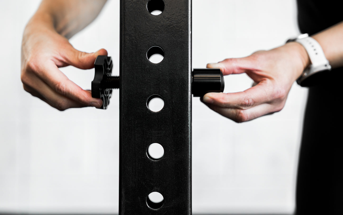 An athlete installing the magnet of the Rack Mounted REP® x Kleva Built® Adroit Landmine on a rack from Rep Fitness UK | Shop Premium Gym Equipment for Home & Commercial Use Online | Best Online Gym Equipment UK