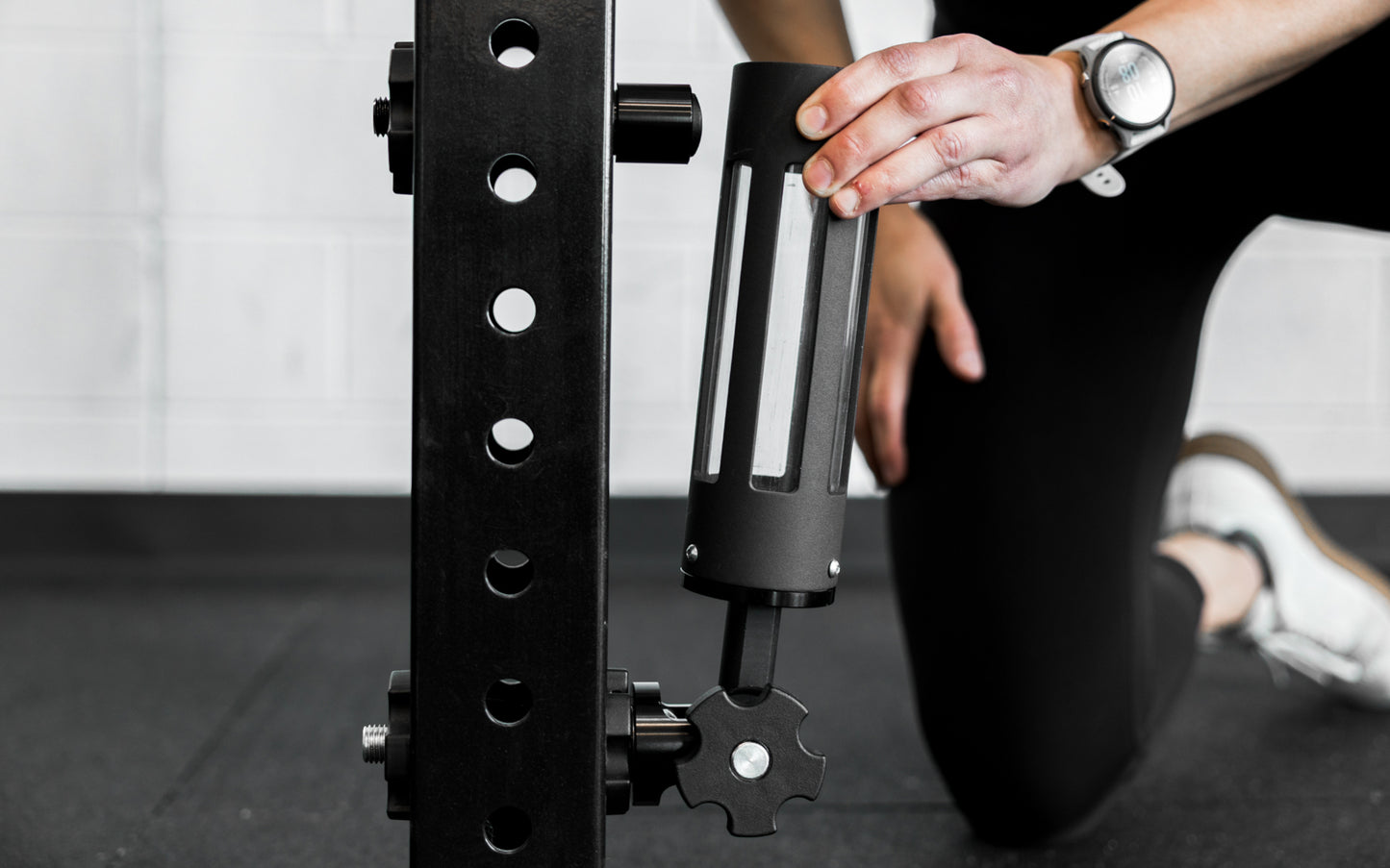 An athlete attaching the base of the Rack Mounted REP® x Kleva Built® Adroit Landmine to the magnetic top piece from Rep Fitness UK | Shop Premium Gym Equipment for Home & Commercial Use Online | Best Online Gym Equipment UK