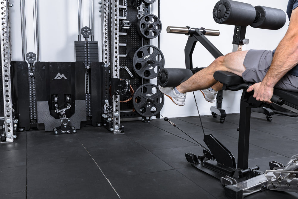 Athlete using only cable resistance on the Leg Extension & Leg Curl Bench Attachment