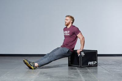 Man doing reverse arm exercises using 24" 3-in-1 Soft Plyo Box on its side, featuring a wood-core interior, impact-absorbing foam, non-slip textured vinyl, and clearly labeled height option for box jumps in home or garage gyms from Rep Fitness UK | Shop Premium Gym Equipment for Home & Commercial Use