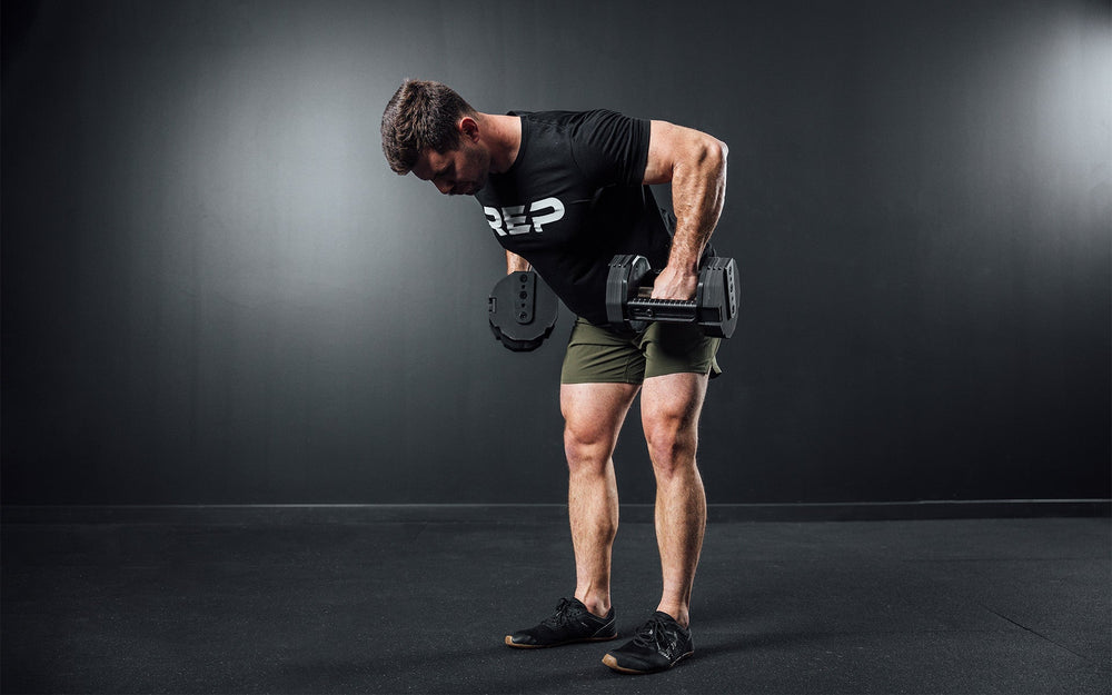 Man lifting two Pepin dumbbells above waist from Rep Fitness UK | Shop Premium Gym Equipment for Home & Commercial Use Online | Best only gym equipment UK