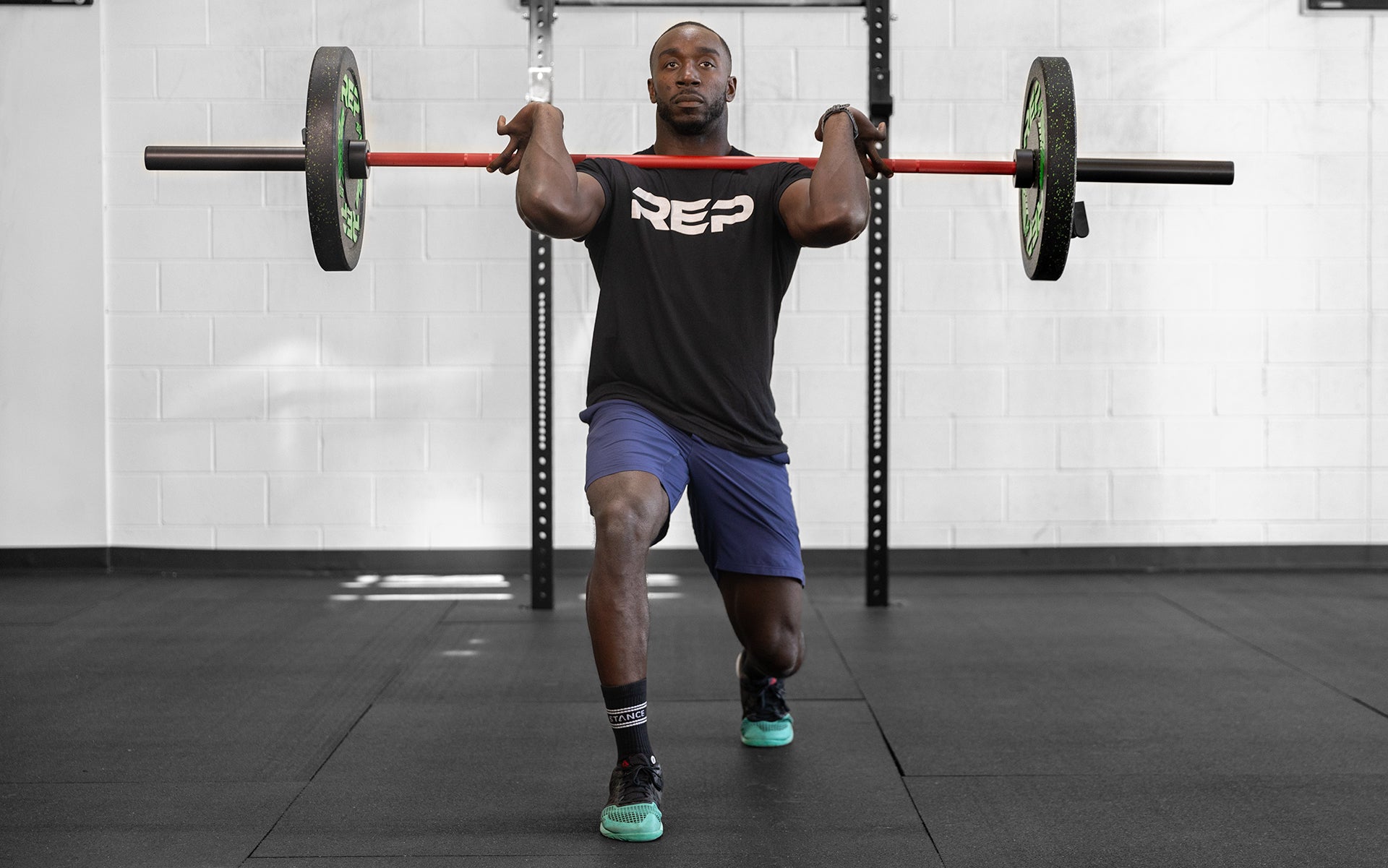 Man lifting with 15 kg Colorado Bar weightlifting bar with a black metal finish, ideal for strength training and gym workouts from Rep Fitness UK | Shop Premium Gym Equipment for Home & Commercial Use Online
