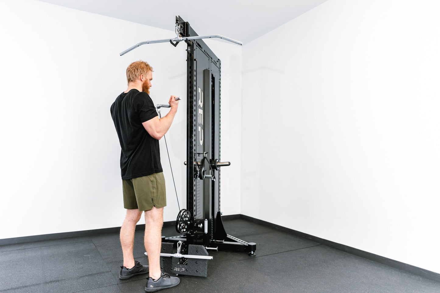 Man standing using Adonis™ Cable Tower plate loaded, Selectorized no Pegasus with base support, premium space-saving cable machine for home or commercial gyms, 1:1 and 2:1 pulley ratios, 34 cable positions, and compatibility with REP’s 5000 Series racks, Pegasus™ attachment, and Modular Storage System for unmatched versatility and performance from Rep Fitness UK | Shop Premium Gym Equipment for Home & Commercial Use, Best Online Gym Equipment