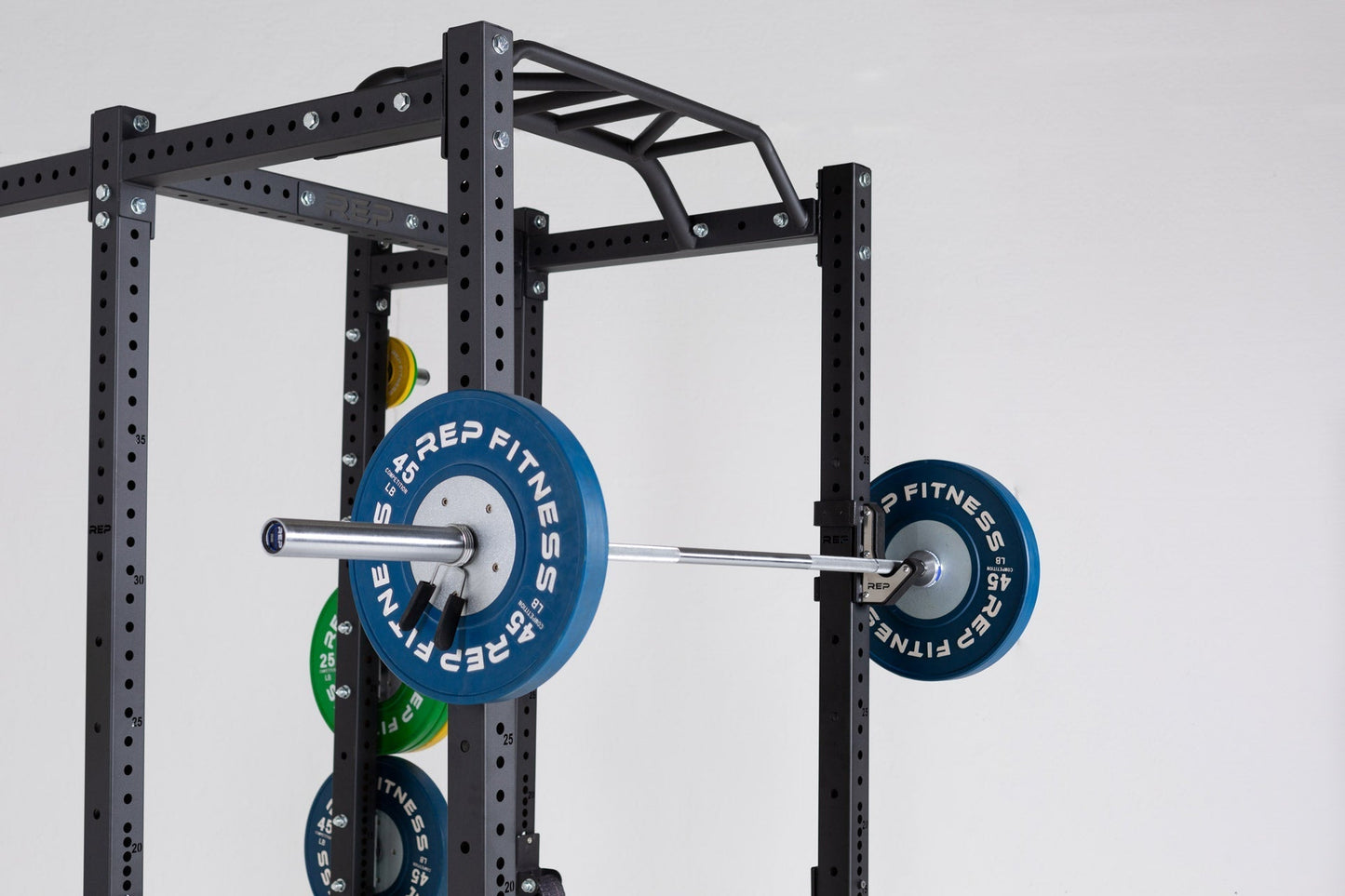 Multi-Grip Pull-Up Bar on Power Rack with barbell, durable 14-gauge steel bar; features 1.25” front and angled/neutral grips, 2” rear bar, multiple grip options (6”–28.4”), attach bands for added versatility, reversible for low ceilings, space-saving home gym pull-up station from Rep Fitness UK | Shop Premium Gym Equipment for Home & Commercial Use, Best Online Gym Equipment