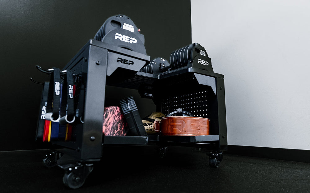 Multipurpose metal storage cart in matte black loaded with dumbbells and weight lifting equipment for organized gym equipment storage from Rep Fitness UK | Shop Premium Gym Equipment for Home & Commercial Use Online