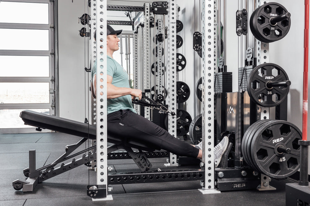 Nighthawk matte black bench man exercising using Ares 2 for reps from Rep Fitness UK | Shop Premium Gym Equipment for Home & Commercial Use Online