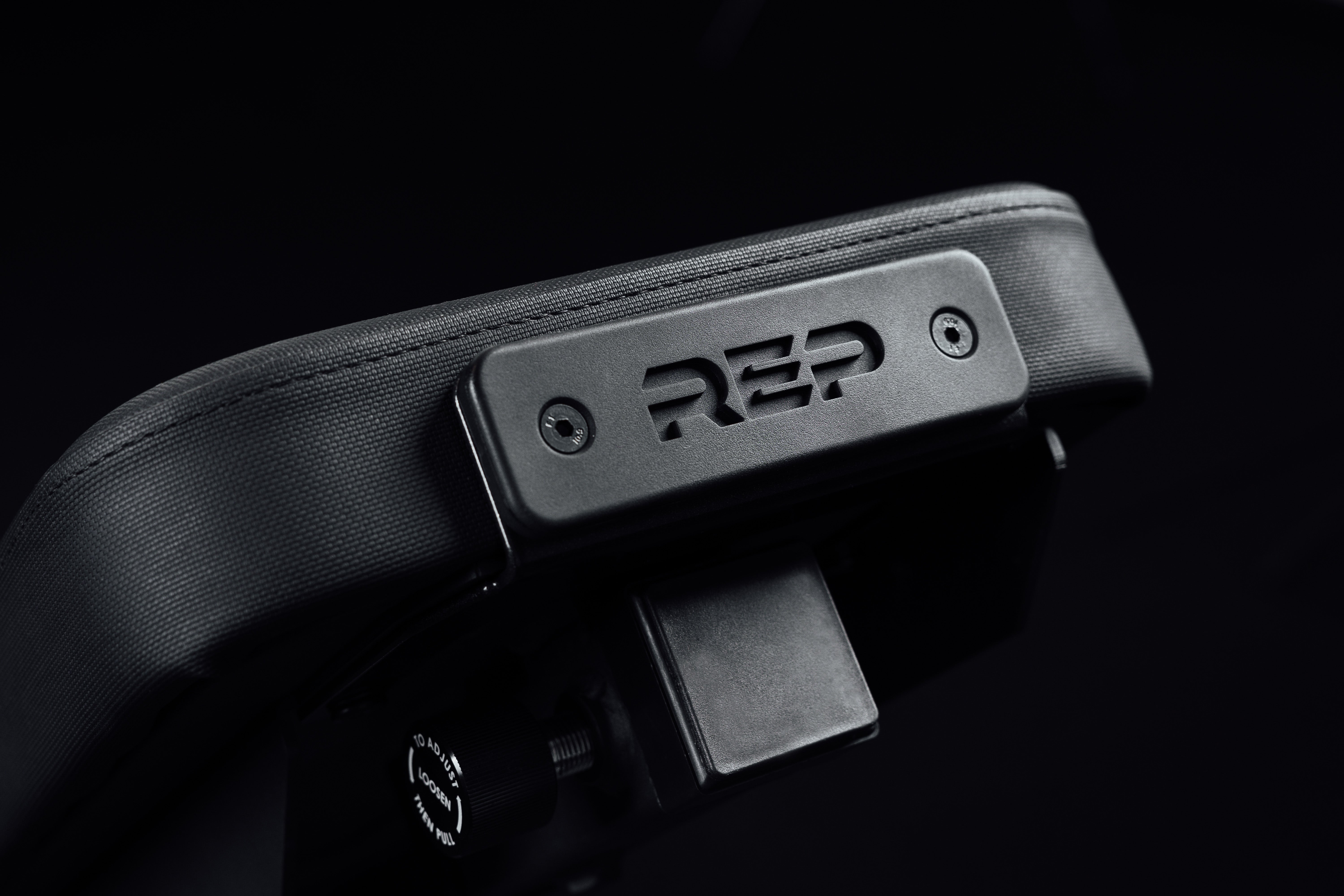 Nighthawk matte black bench pad closeup sideview with metal brand icon from Rep Fitness UK | Shop Premium Gym Equipment for Home & Commercial Use Online