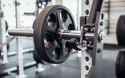Female athlete performing a deadlift with the REP Open Trap Bar.