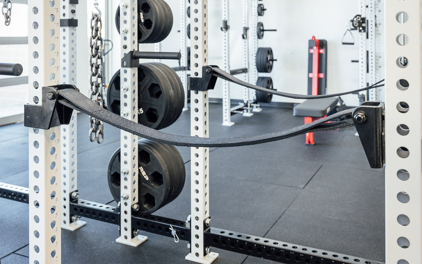 Pair of 5000 Series Strap Safeties 2.0 on PR-5000 Power Rack, heavy-duty reinforced nylon safety straps for PR-5000, Omni, and 1000 Series power racks; ultra-durable, barbell-protecting, noise-reducing design with 1,000lb capacity, adjustable height ends, and patent-pending anti-rotation brackets for safe and versatile strength training from Rep Fitness UK | Shop Premium Gym Equipment for Home & Commercial Use, Best Online Gym Equipment