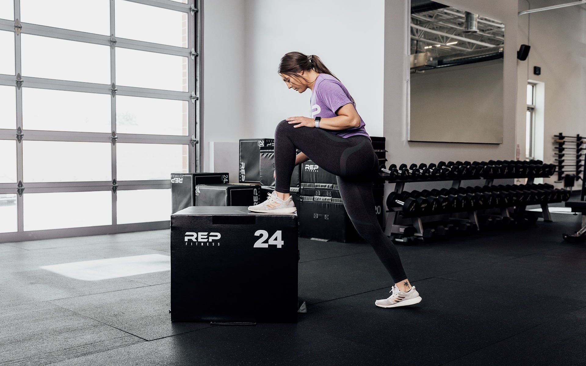 Female athlete stretching against a 24
