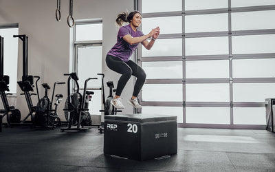 Female athlete performing box jumps on a 20" REP Stackable Soft Plyo Box from Rep Fitness UK | Shop Best Premium Gym Equipment for Home & Commercial Use Online