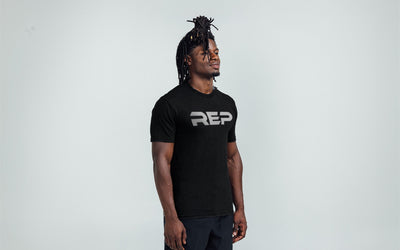 Man wearing Heather Black/White Men's Daily Driver 2.0 Tri-Blend Crew