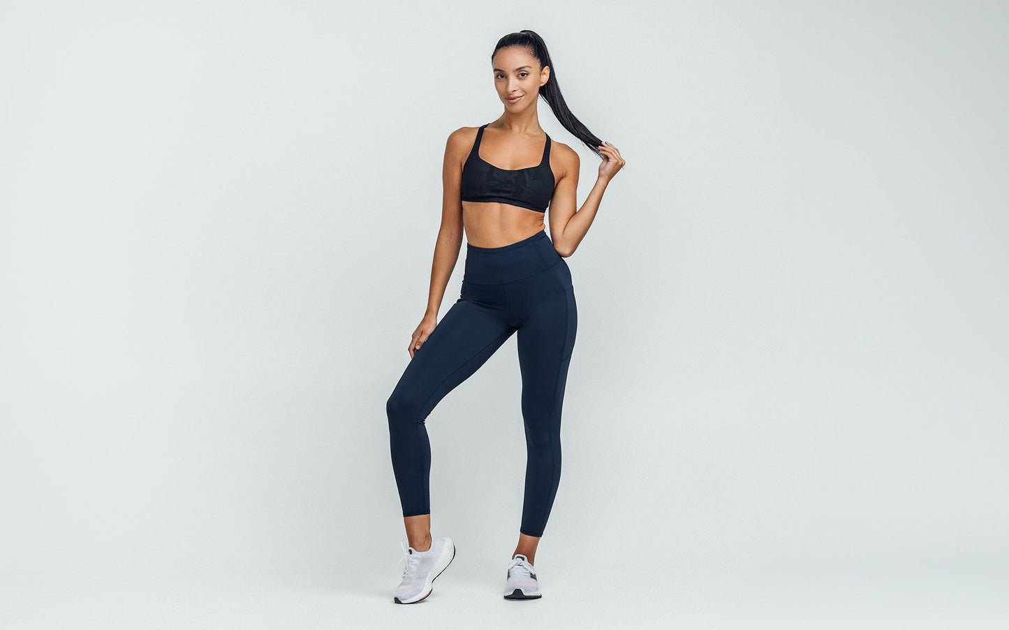 Women's Leggings- Front view of model wearing the REP Hera Tights in navy on a gray background