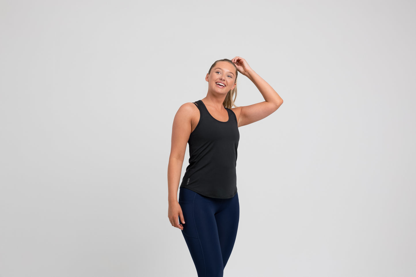 Athlete wearing a black REP Women’s Clio Tank Top.