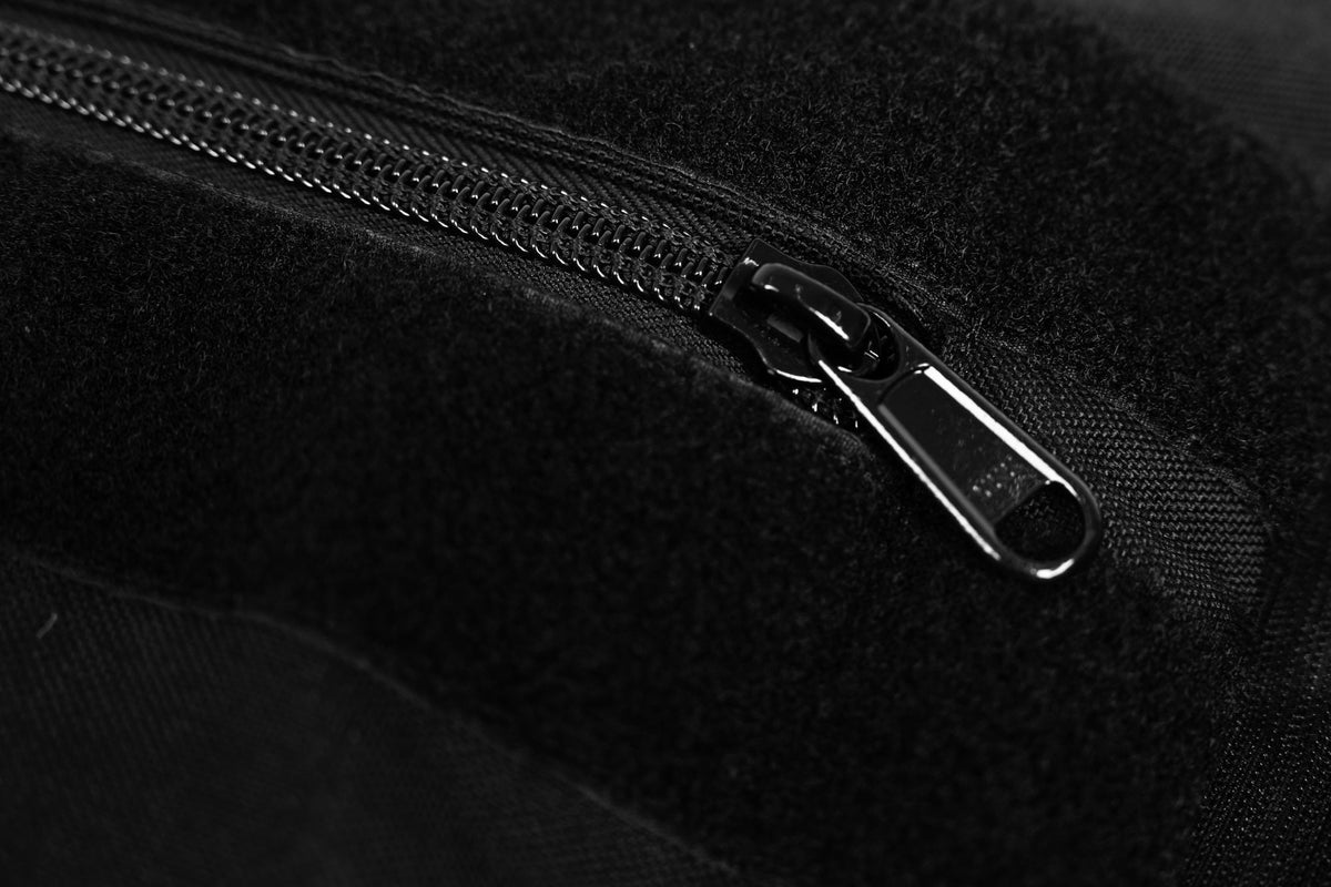 Close-up of a black zipper on stone sandbag