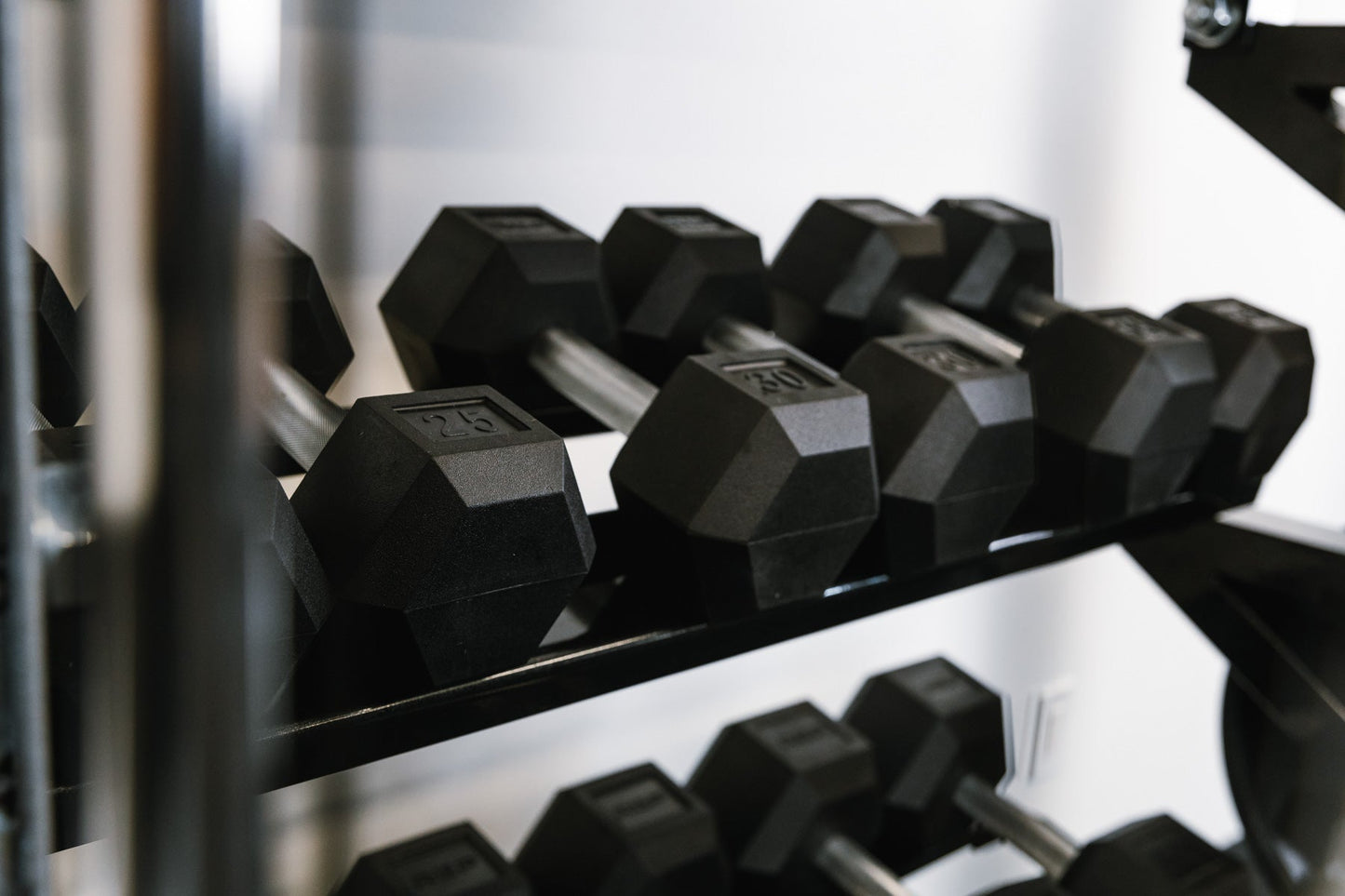 Set of dumbbells on Dumbbell Storage Shelf – heavy-duty 11-gauge steel dumbbell rack shelf with 600lb capacity, metallic black powder-coat finish, laser-cut REP logo, compatible with 4000 and 5000 Series racks, fits full 5–50lb dumbbell sets for organized, space-saving gym storage from Rep Fitness UK | Shop Premium Gym Equipment for Home & Commercial Use, Best Online Gym Equipment UK