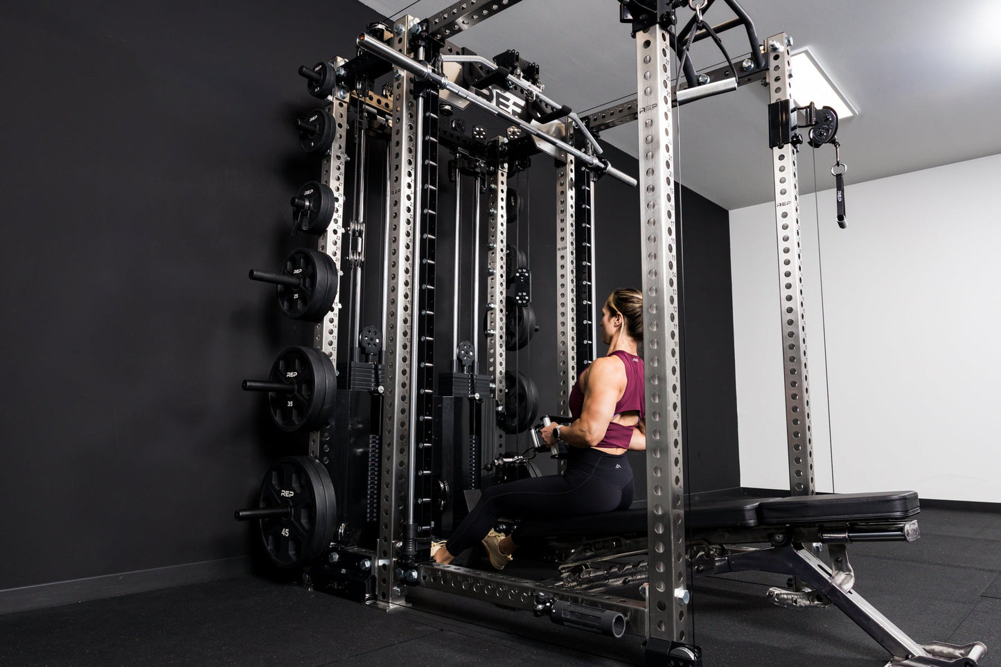 Lady sat down going through her work out in a  Ares™2.0 builder  from REP Fitness