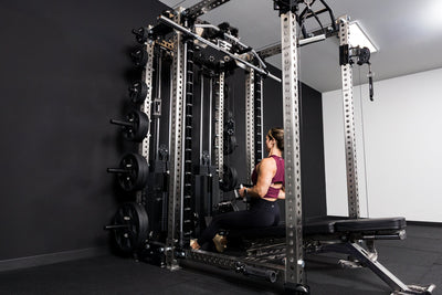 Lady sat down going through her work out in a  Ares™2.0 builder  from REP Fitness
