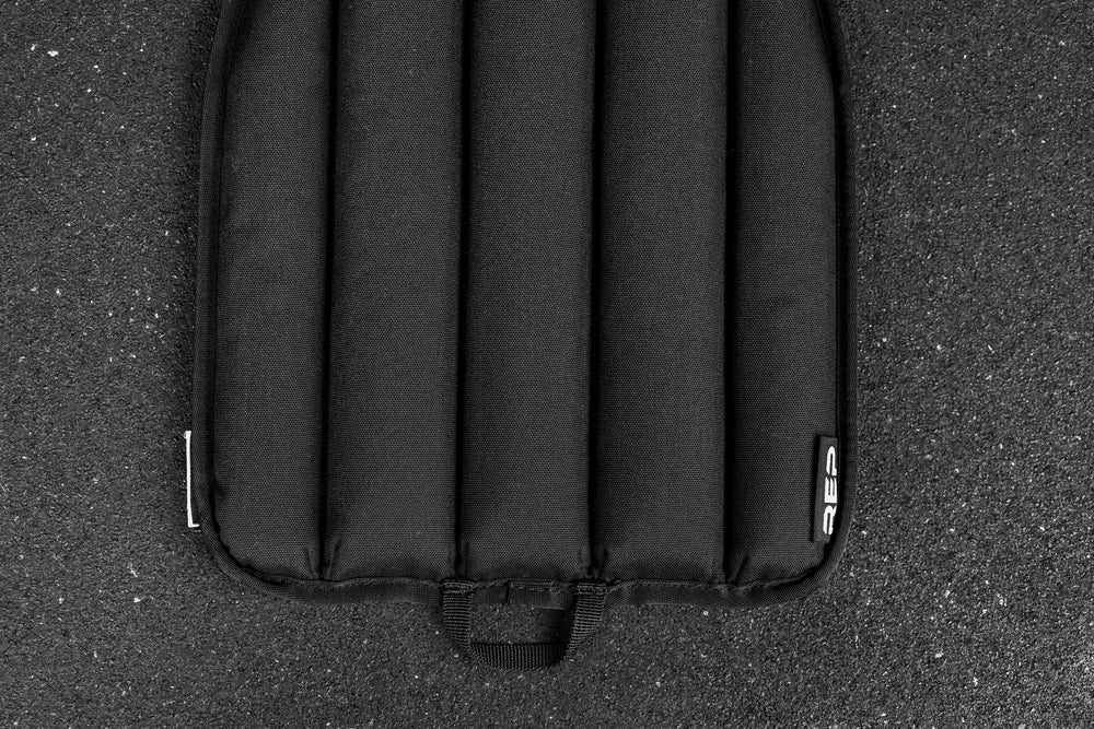 Black soft weight vest plate on a textured black surface