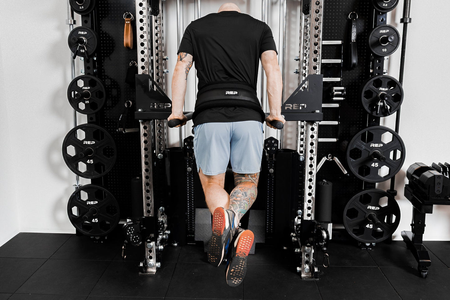 Person using belt squat belt for weighted dips from Rep Fitness UK | Shop Best Premium Gym Equipment for Home & Commercial Use Online