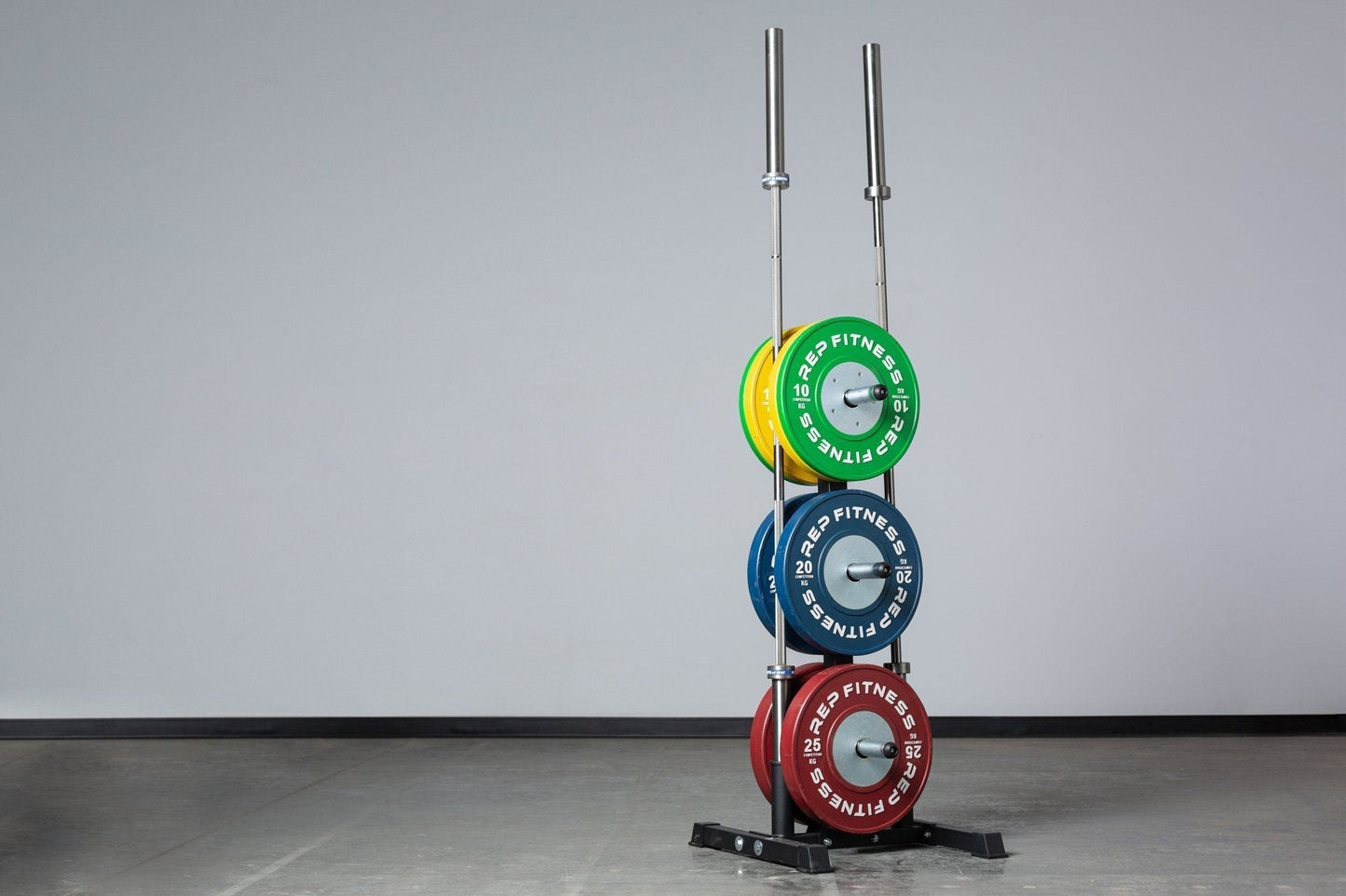 Stack of weight plates on Bar and Weight Plate Tree with two barbell holders, heavy-duty storage for organized gym equipment storage and easy access in home and commercial fitness spaces from  Rep Fitness UK | Shop Premium Gym Equipment for Home & Commercial Use Online | Best Gym Equipment UK