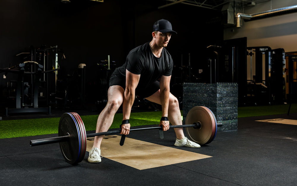An athlete deadlifting with Rep Fitness Calibrated Steel Plates (KG) loaded on the barbell, highlighting how thin the plates are from Rep Fitness UK | Shop Best Premium Gym Equipment for Home & Commercial Use Online