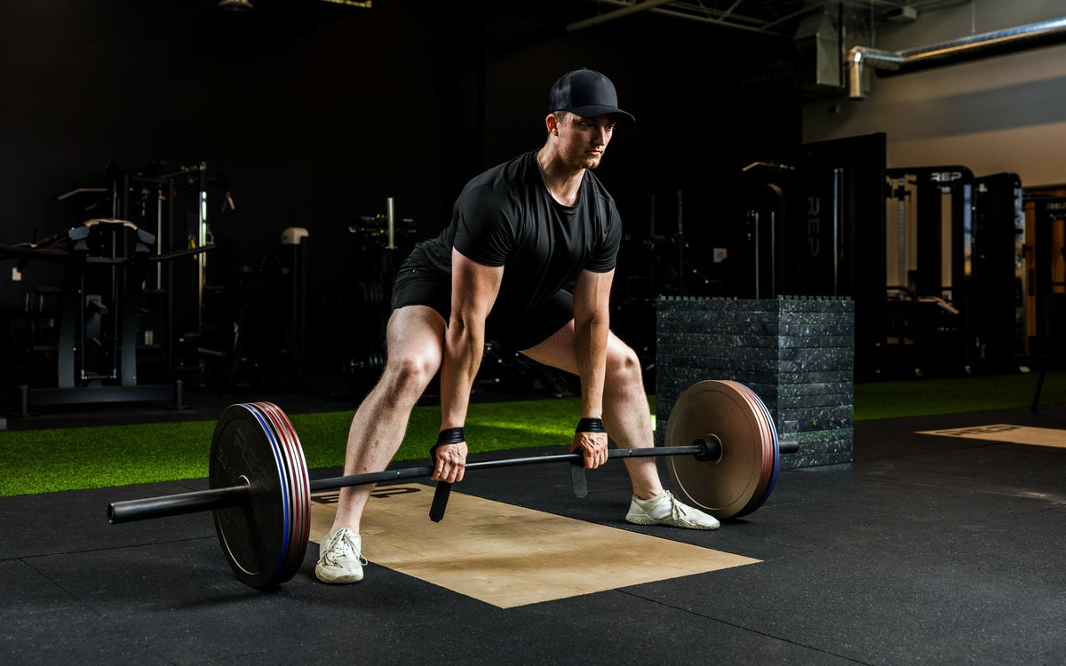 An athlete deadlifting with Rep Fitness Calibrated Steel Plates (KG) loaded on the barbell, highlighting how thin the plates are from Rep Fitness UK | Shop Best Premium Gym Equipment for Home & Commercial Use Online