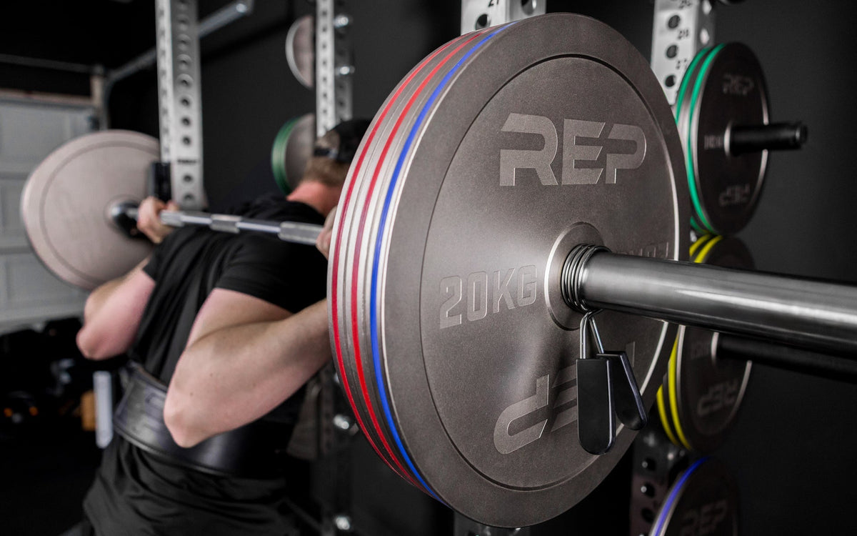 Athlete squatting with Rep Fitness Calibrated Steel Plates (KG), highlighting their thin size and IPF Specs for powerlifting from Rep Fitness UK | Shop Best Premium Gym Equipment for Home & Commercial Use Online