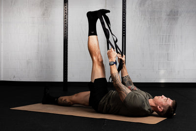 Person using a looped stretching strap for assisted flexibility and mobility training from Rep Fitness UK | Shop Best Premium Gym Equipment for Home & Commercial Use Online