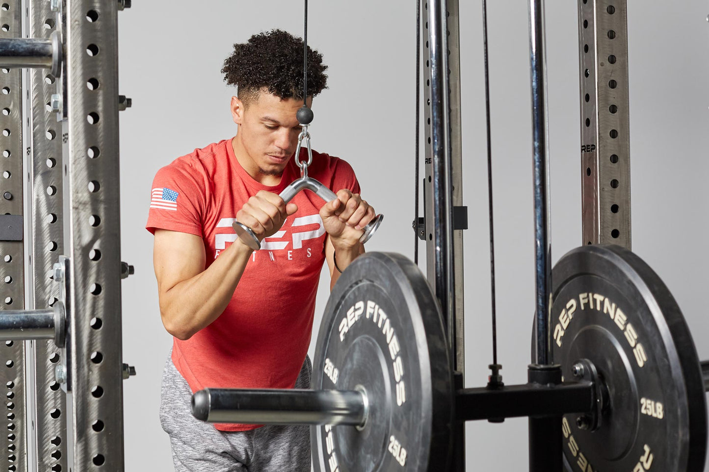 Tricep Pressdown Bar In Use add more options to your functional trainer or cable machine with this attachment from Rep Fitness UK | Shop Best Premium Gym Equipment for Home & Commercial Use Online