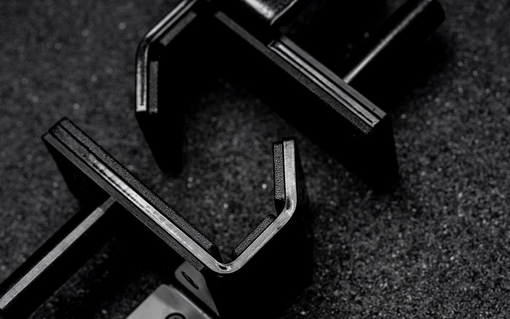 Two Standard J-Cups 2.0 – heavy-duty barbell holders for PR-5000 power rack; 3x3” 11-gauge steel with metallic black powder coat, soft plastic lining, recessed hardware, and 1,000 lb capacity for safe, scratch-free, and stable lifting on the floor from Rep Fitness UK | Shop Premium Gym Equipment for Home & Commercial Use, Best Online Gym Equipment UK