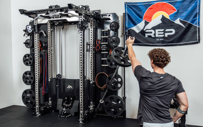 An athlete using the Rack Mounted REP® x Kleva Built® Adroit Landmine to do presses on the Wall-Mounted Ares™ 2.0 from Rep Fitness UK | Shop Premium Gym Equipment for Home & Commercial Use Online | Best Online Gym Equipment UK