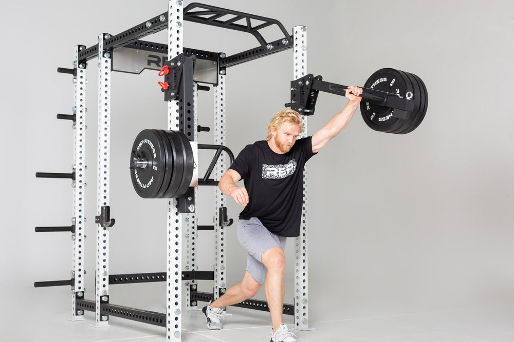 Weight Horns 5000 Series on PR-5000 Power Rack being used by man, Weight Horns 5000 Series on PR-5000 Power Rack Weight Storage, Weight Horns 5000 Series 30 cm Pair, heavy-duty steel weight horns for 5000 Series; bolt-on design, holds up to 315 lbs of plates, rubber gasket stops protect weights, and compact storage solution for organized home or commercial gyms from Rep Fitness UK | Shop Premium Gym Equipment for Home & Commercial Use, Best Online Gym Equipment UK