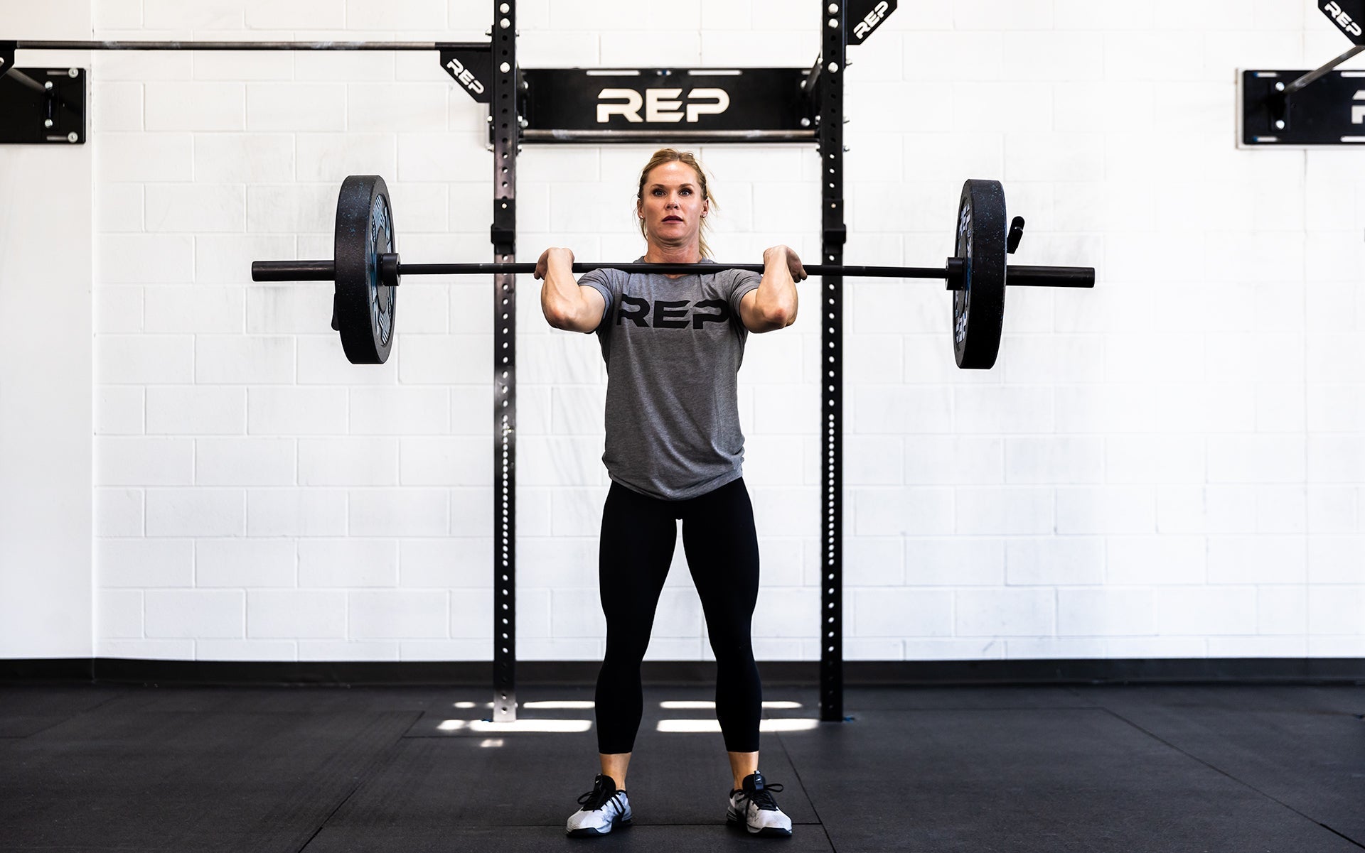 Woman lifting with 15 kg Colorado Bar weightlifting bar with a black metal finish, ideal for strength training and gym workouts from Rep Fitness UK | Shop Premium Gym Equipment for Home & Commercial Use Online| Best Online Gym Equipment UK