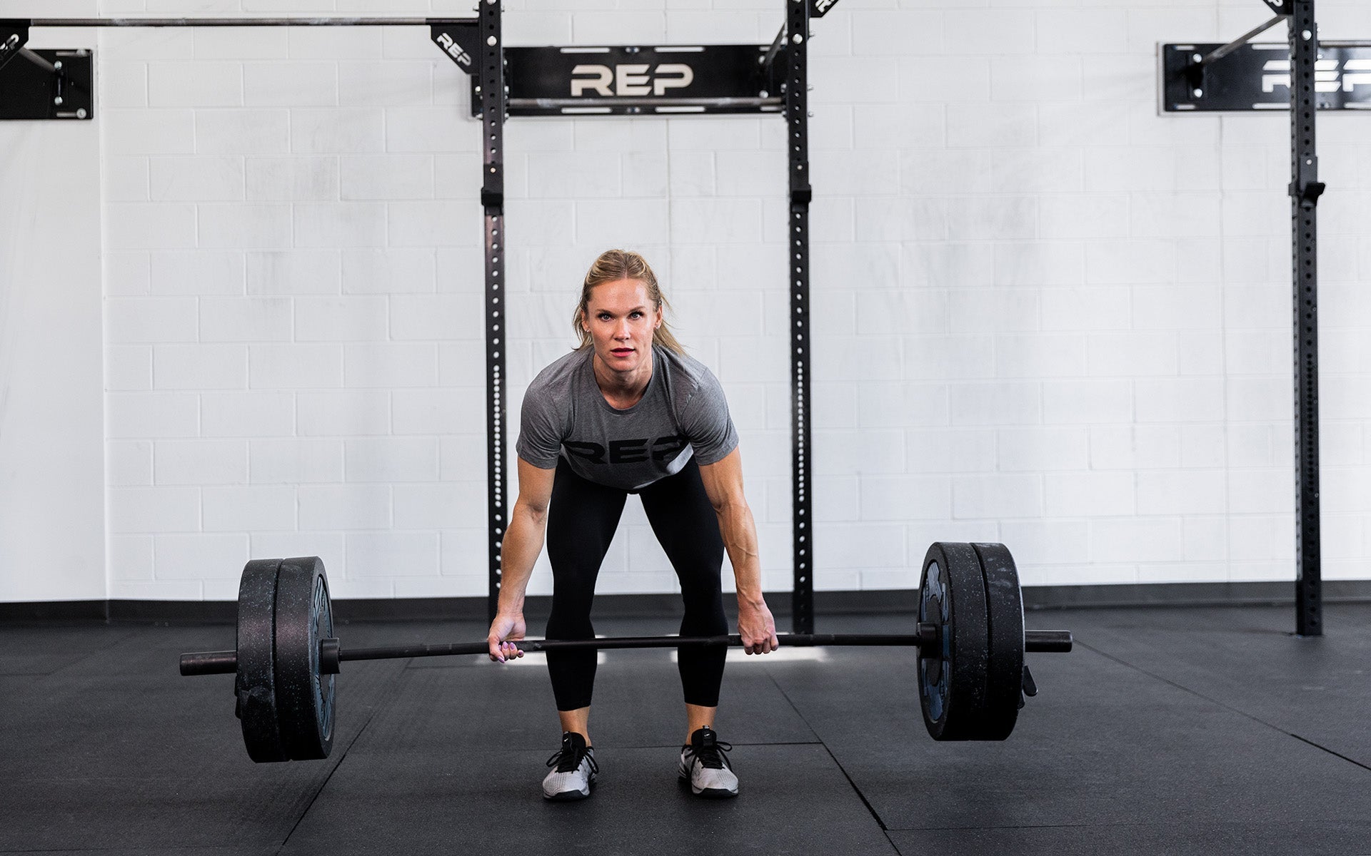 Woman using 15 kg Colorado Bar weightlifting bar for powerlifting, ideal for strength training and gym workouts from Rep Fitness UK | Shop Premium Gym Equipment for Home & Commercial Use Online| Best Online Gym Equipment UK
