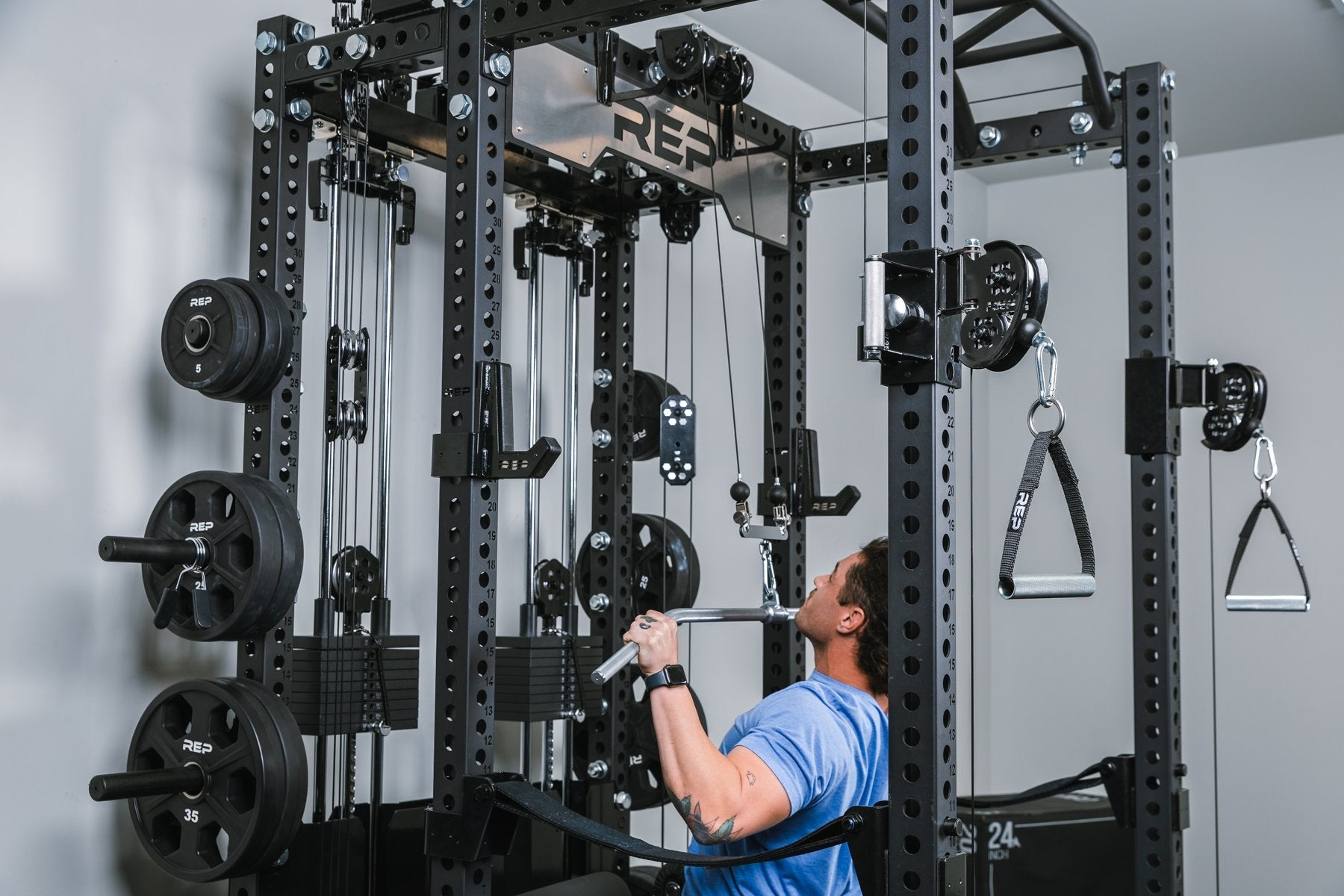 Incline press inside a rack that has a Ares™2.0 builder being put through it paces in a home gym.