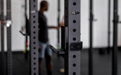 close-up side view of standard J-Cups 2.0 – heavy-duty barbell holder for PR-5000 power rack; 3x3” 11-gauge steel with metallic black powder coat, soft plastic lining, recessed hardware, and 1,000 lb capacity for safe, scratch-free, and stable lifting mounted on matte black power rack upright  from Rep Fitness UK | Shop Premium Gym Equipment for Home & Commercial Use, Best Online Gym Equipment UK