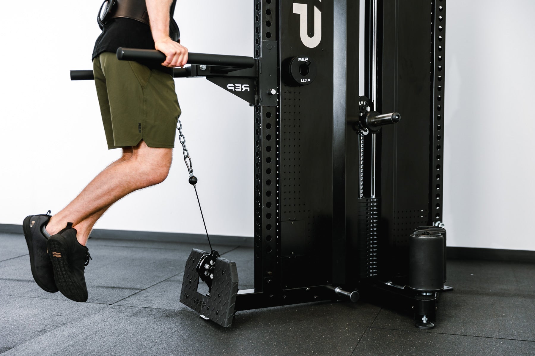 man doing dips on Adonis™ Cable Tower plate loaded, Selectorized no Pegasus with base support, premium space-saving cable machine for home or commercial gyms, 1:1 and 2:1 pulley ratios, 34 cable positions, and compatibility with REP’s 5000 Series racks, Pegasus™ attachment, and Modular Storage System for unmatched versatility and performance from Rep Fitness UK | Shop Premium Gym Equipment for Home & Commercial Use, Best Online Gym Equipment