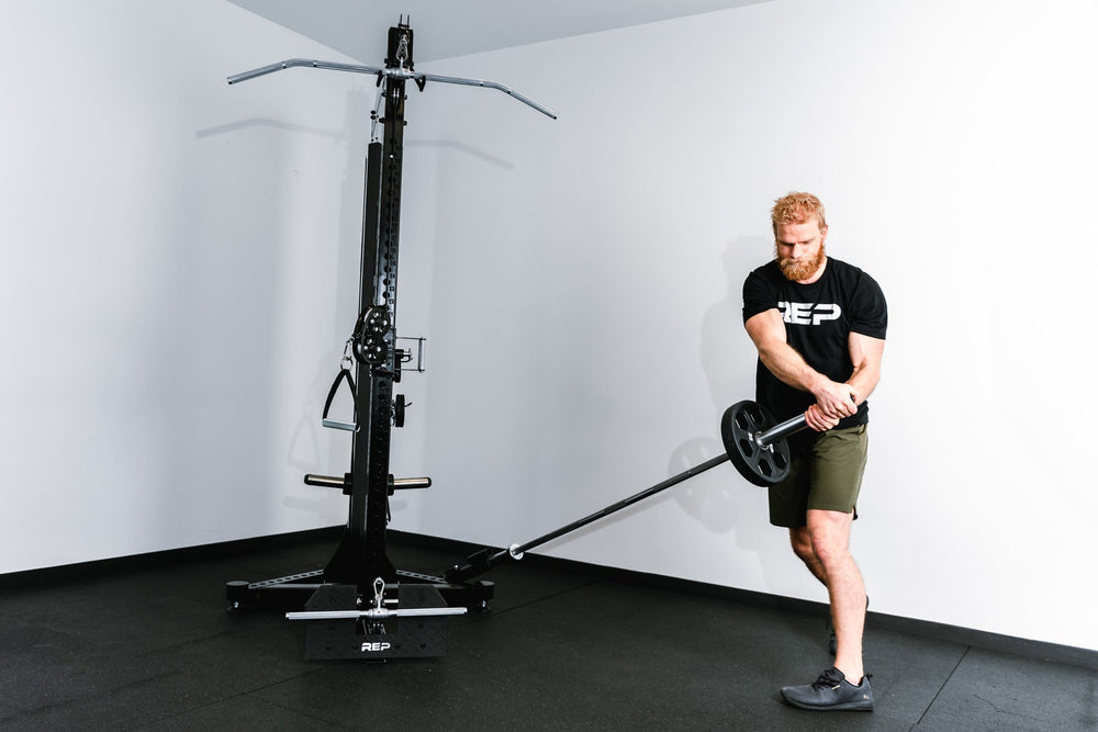 man using landmine bar attachment on Adonis™ Cable Tower plate loaded, Selectorized no Pegasus with base support, premium space-saving cable machine for home or commercial gyms, 1:1 and 2:1 pulley ratios, 34 cable positions, and compatibility with REP’s 5000 Series racks, Pegasus™ attachment, and Modular Storage System for unmatched versatility and performance from Rep Fitness UK | Shop Premium Gym Equipment for Home & Commercial Use, Best Online Gym Equipment