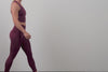 A video of an athlete putting their phone into the back pocket of the Women's Eos Tights