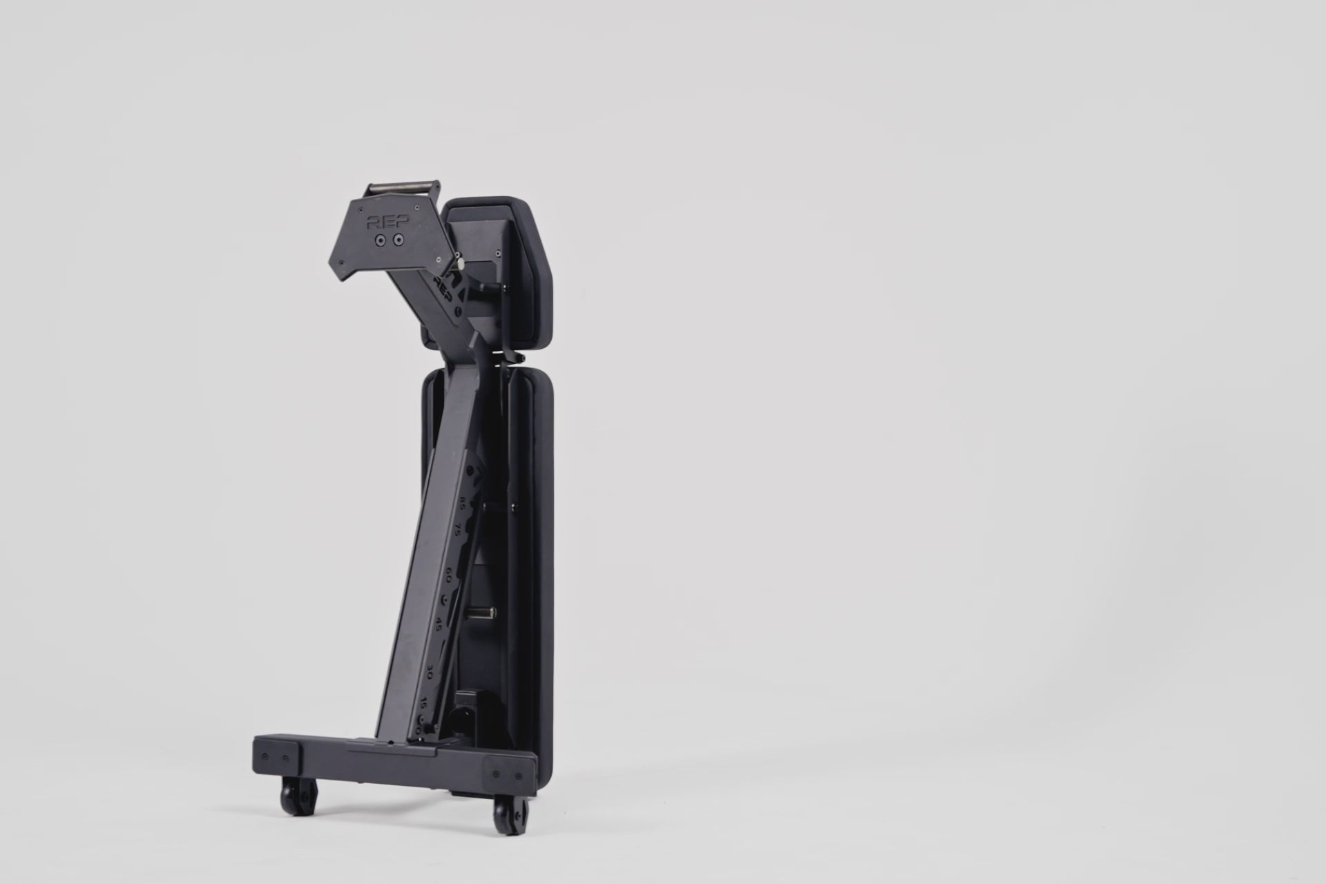 video of the nighthawk being vertically stored compact, high-performance bench for home and light-commercial gyms; 7- and 14-gauge steel frame, 7 back and 4 seat positions, CleanGrip™ vinyl pad, knurled handle, heavy-duty wheels, IPF-compliant 16.7” height, vertical storage, and compatibility with leg curl and roller attachments from Rep Fitness UK | Shop Best Premium Gym Equipment for Home & Commercial Use Online