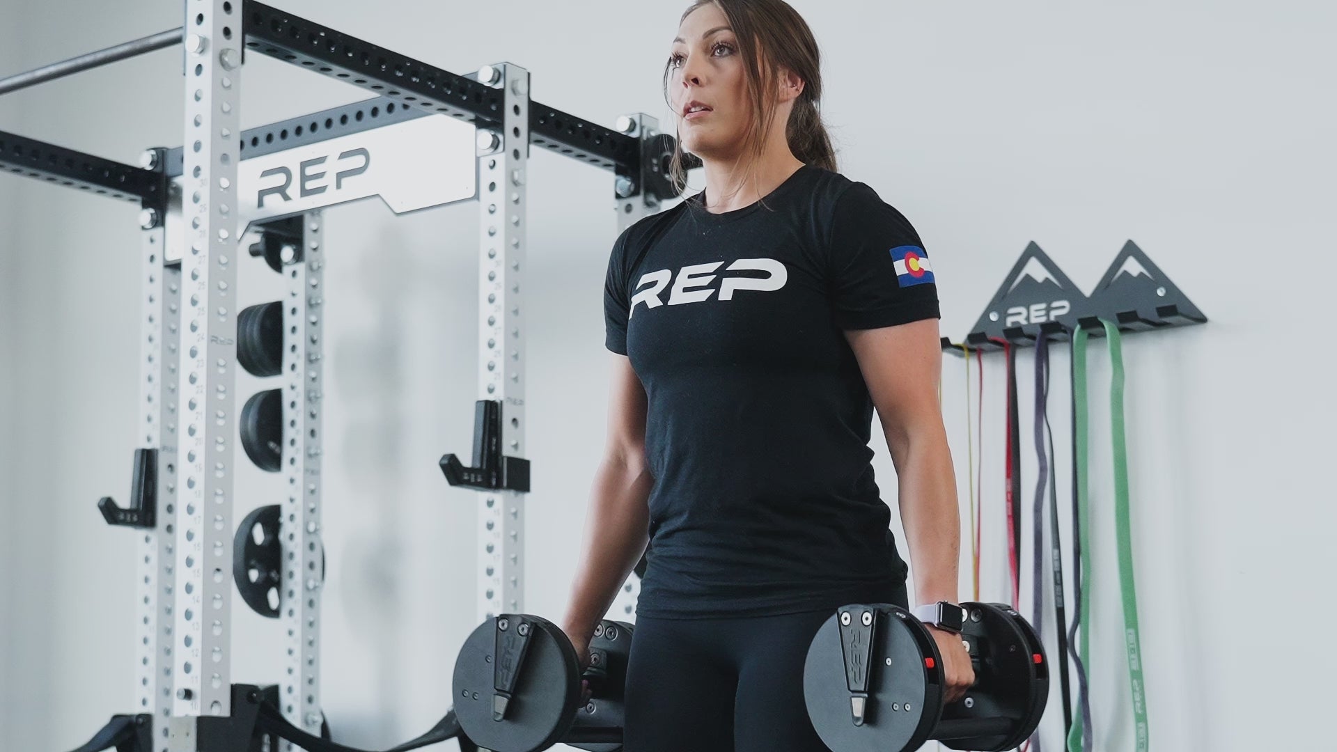 Woman exercising using Premium QuickDraw dumbbells with adjustable weight, fast switch adjustable  weight range technology and secure Lock-N-Load switches for high-performance strength training from Rep Fitness UK | Shop Premium Gym Equipment for Home & Commercial Use, Best Online Gym Equipment