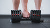 Man gripping handle of durable Premium QuickDraw dumbbells with adjustable weight, fast switch adjustable  weight range technology and secure Lock-N-Load switches for high-performance strength training from Rep Fitness UK | Shop Premium Gym Equipment for Home & Commercial Use, Best Online Gym Equipment