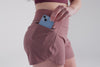 Video: Athlete putting their phone in the zipper pocket of the Mauve REP Artemis Short