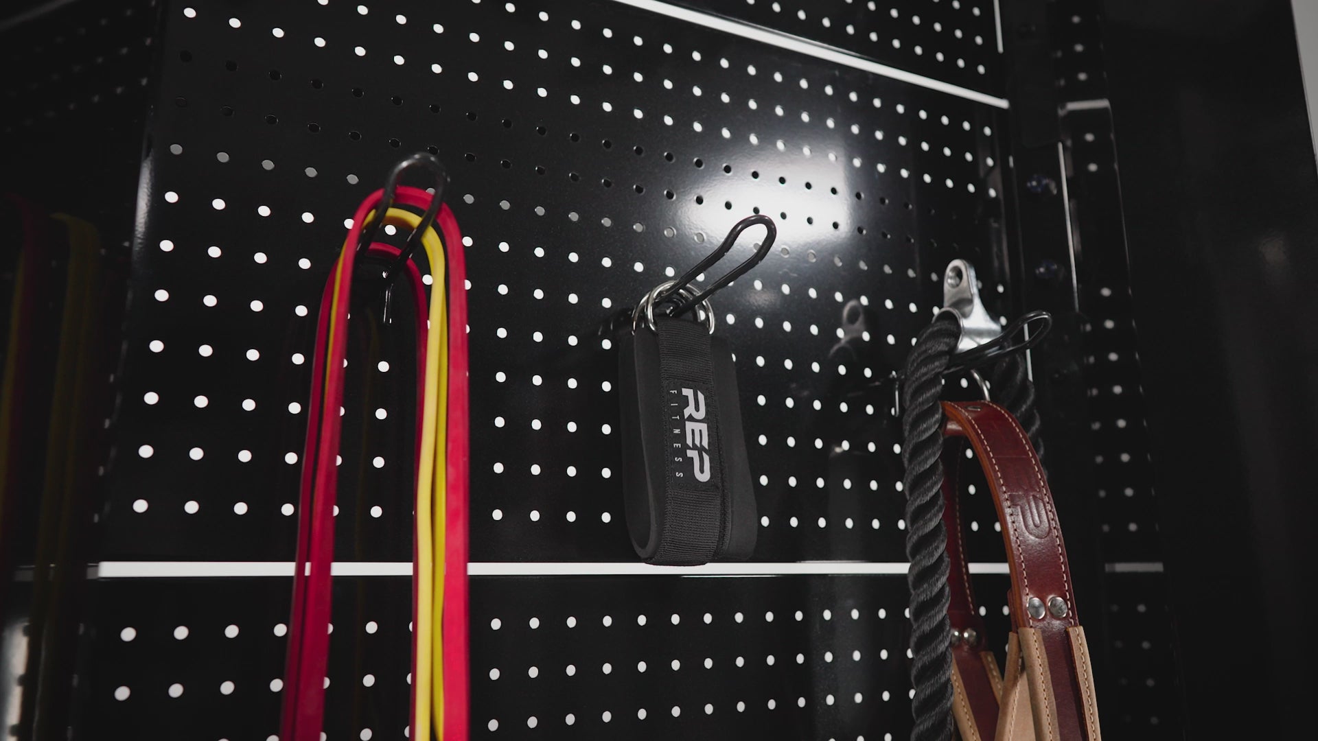 Video of someone taking off an attachment from the pegboard of the Arcadia™ max stand-alone functional trainer, premium full-sized cable machine from Rep Fitness UK | Shop Premium Gym Equipment for Home & Commercial Use Online.