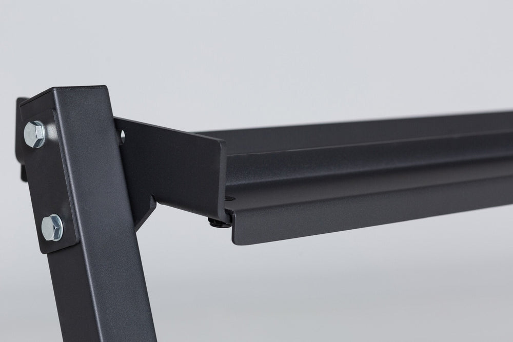 Close-up view of the top of the left support post and top shelf of a REP Dumbbell Rack. Close-up side view of the bottom of the 3-tiered matte black REP Dumbbell Rack showcasing the "REP" logo, bottom shelf, and rubber foot. 3-tiered matte black REP Dumbbell Rack storing a 5-50 REP dumbbell set, heavy-duty three-tier dumbbell rack with durable 11-gauge steel shelves, compact footprint, and 1" lip for secure storage  fits REP rubber hex and urethane dumbbells, available in multiple colors with easy zinc-coat